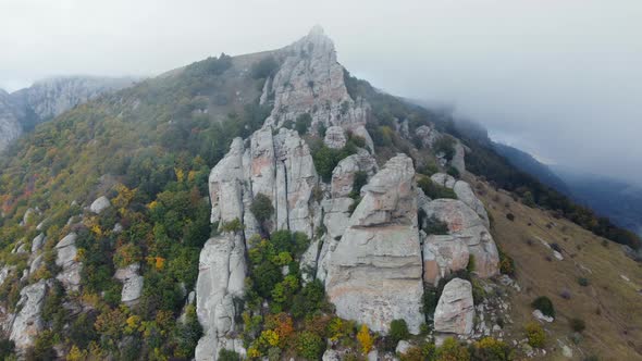 Mountains with Rocky Sculptures That are Getting Covered By Clouds