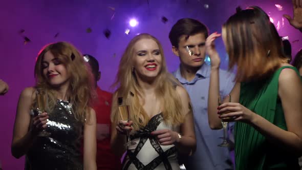 Young Girls Dance and Chat with Glass of Champagne