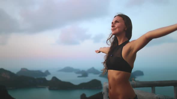 Bokeh Thailand's Sunset Woman Rising Up Hands to Cloudy Sky at Thai Marine Park with Green Islets