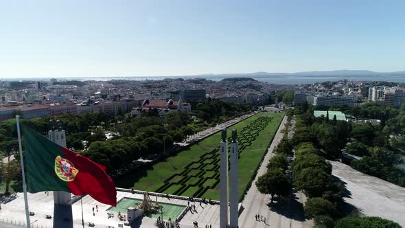 Aerial View of Portugal Flag Waving in the Wind on Eduardo VII Park Lisbon