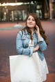 portrait of beautiful woman with shopping bag on street - PhotoDune Item for Sale