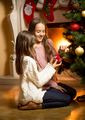 cute girls sitting on floor and decorating Christmas tree - PhotoDune Item for Sale