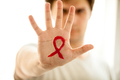photo of man showing hand with drawn red AIDs loop - PhotoDune Item for Sale