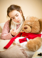 little girl giving pills to sick teddy bear - PhotoDune Item for Sale