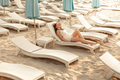 shot of sexy woman enjoying rest on sunbed at beach - PhotoDune Item for Sale