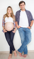 couple waiting for baby posing in jeans and shirts - PhotoDune Item for Sale