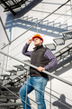 male worker in hardhat standing on steel staircase - PhotoDune Item for Sale