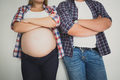closeup photo of pregnant woman and husband leaning on white wall - PhotoDune Item for Sale