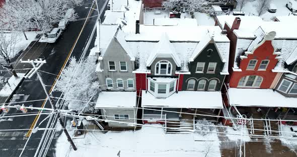 Truck shot of colorful old Victorian homes in winter snow. American town after fresh snowfall. Town