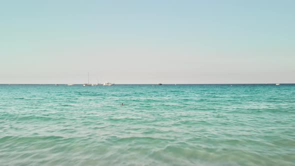 Unrecognized Girl Tourist Goes Into the Sea with an Inflatable Swimming Circle. Summer Vacation