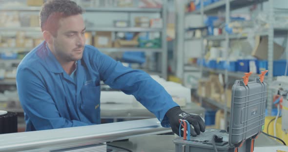 Worker testing LED lamp in an advanced electronics manufacturing facility