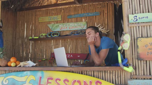 Caucasian man using his laptop at beach