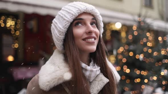 Girl Enjoying Snowfall on the Street