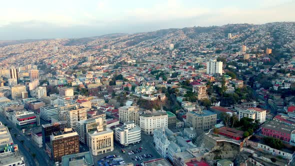 Aerial dolly in of Plaza Sotomayor, Chilean Army building and Baburizza Palace in Cerro Alegre, Valp