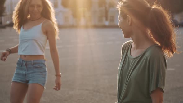 Outdoor Portrait of Two Hipster Friends with Skateboard High Five in Sunshine City. Two Fashion