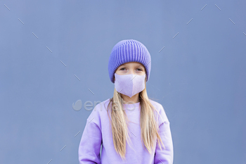 Candid Portrait of Cute Little Girl in Face Mask Outdoor. Trendy Color of the 2022 Year Very Peri