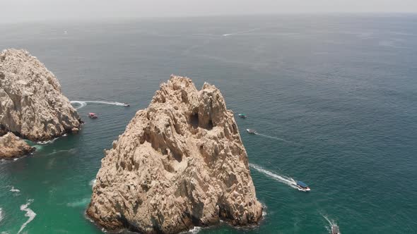 Aerial View of Rock Formation and Boats in Ocean