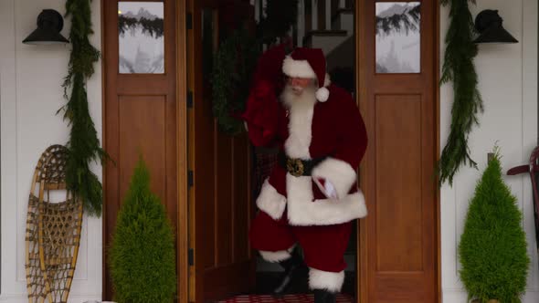 Santa Claus coming out of house alt
