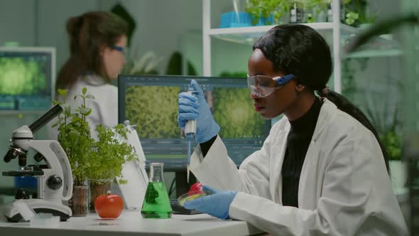 Biologist Scientist African Woman Researcher Taking Genetic Solution From Test Tube