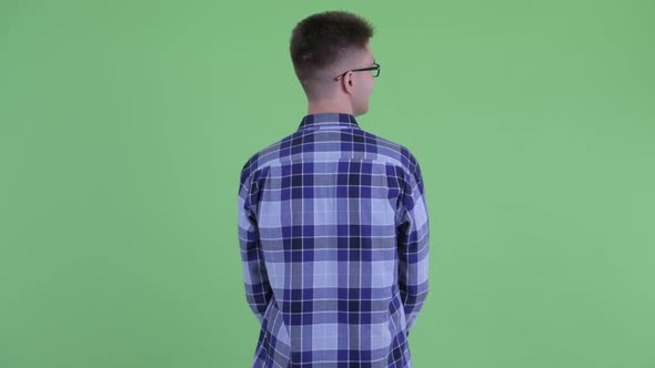 Rear View of Young Hipster Man Thinking and Looking Around