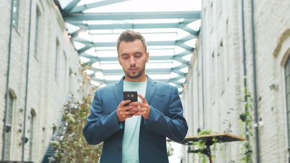 Young successful caucasian businessman works outdoor