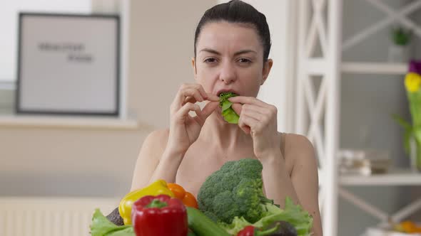 Front View Joyful Young Confident Millennial Woman Eating Green Salad Leaf Looking at Camera Smiling