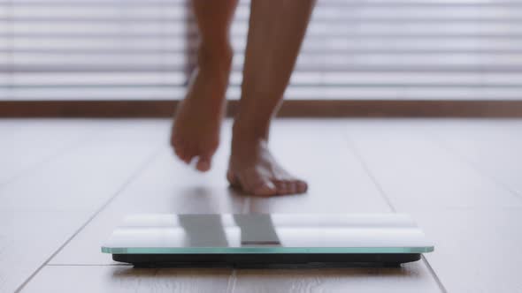 Closeup Slender Female Legs Unrecognizable Woman Walking Barefoot Across Room Stepping on Electronic