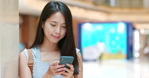 Woman use of cellphone in shopping mall