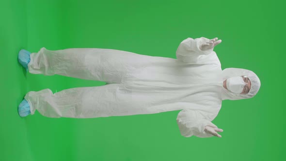 Male Wear Protective Uniform PPE Blowing Kisses To A Camera In The Green Screen Studio