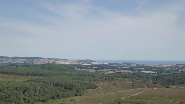 Panorama view of agricultural fields and coast in Woodbury, England.