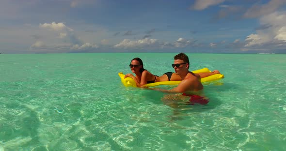 Fun couple married on vacation have fun on beach on white sand 4K background