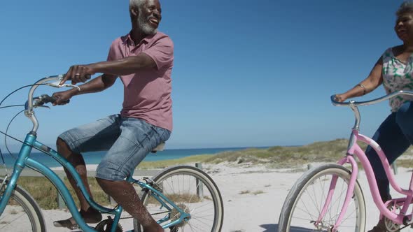 Senior woman on a bike at the beach