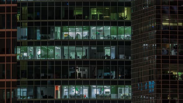 Close Up View to Office Windows in Skyscrapers of City at Night Timelapse From Top alt