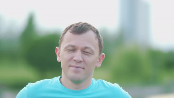 Portrait of a Young Man Outdoors Smiling and Looking at the Camera Camera Movement