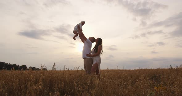 A Young Couple Is Playing With Their Child On Vacation