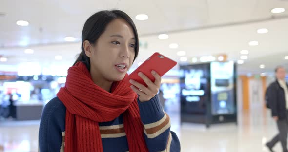 Woman look at mobile phone in side shopping center