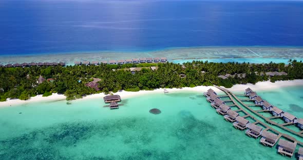 Natural fly over travel shot of a summer white paradise sand beach and aqua blue ocean background in