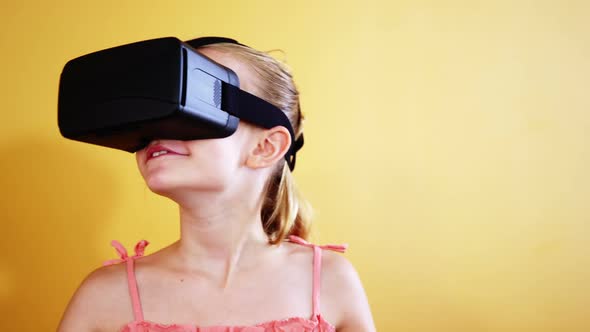 Schoolgirl using virtual reality glasses in classroom