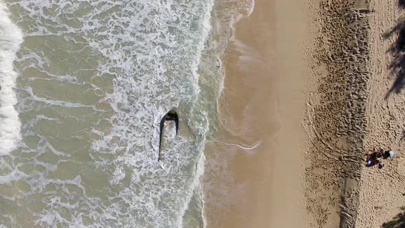Aerial shot of partially sunken boat at Bellows Field Beach Park.