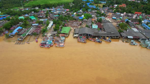 Aerial shot of river and local fisherman village beside the sea