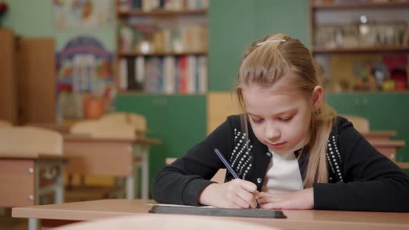 An Elementary School Student Diligently Does Her School Assignment