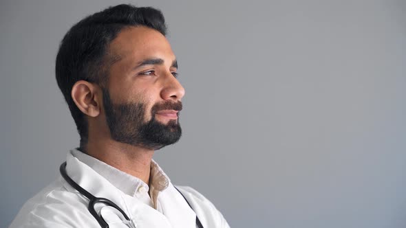 Close Up Portrait of Indian Family Medical Doctor Turning Face Smiling to Camera