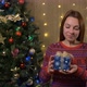 Young Beautiful Woman Shakes Box with Christmas Gift - VideoHive Item for Sale