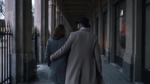 Couple in Business Clothes Walks Down the Street