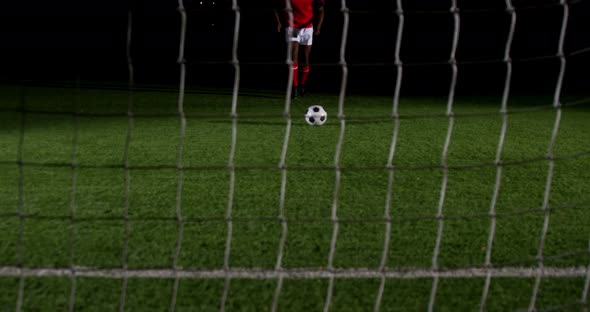 Soccer player scoring a goal against open goal post 4k