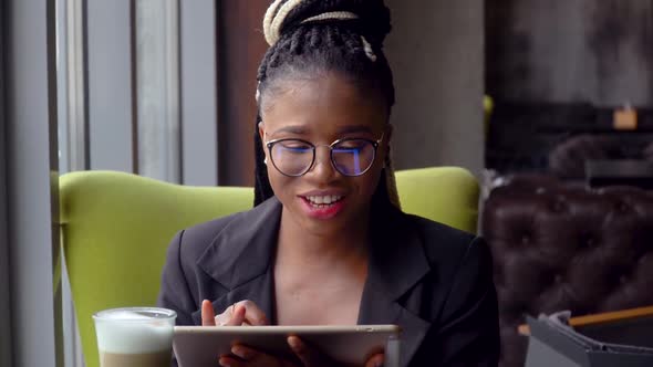 Happy African American Young Woman Communicating By Conference Call Speak Looking in Tablet