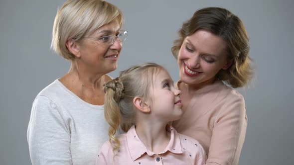 Adorable Girl Hugging With Mother and Granny, Children Rights, Good Parenting