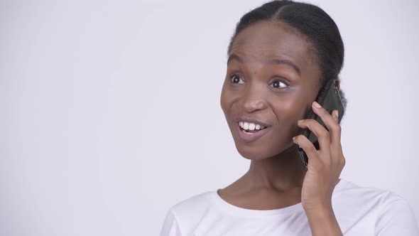 Face of Happy Young Beautiful African Woman Thinking While Talking on the Phone