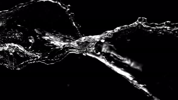 Super Slow Motion Shot of Swirling and Splashing Water Isolated on Black Background at 1000Fps