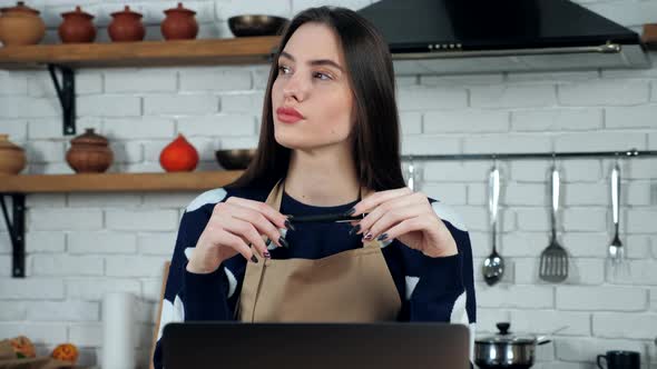 Thoughtful woman in apron thinks solution problem holiday restaurant food menu